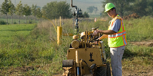 A gas utility student digs a line in the gas utility field at the Peosta campus.