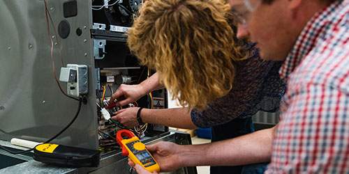 Female and male student work in HVAC program