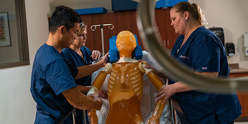 A group of respiratory students work in a sim lab