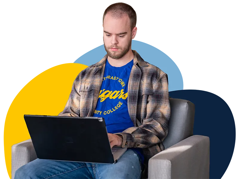 An NICC student working on his laptop.