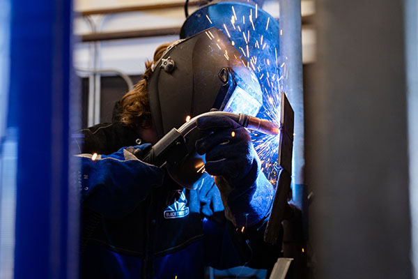 An NICC welding student working in the welding lab.