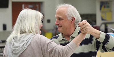A mature couple learning dance steps