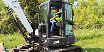 A student operating heavy equipment