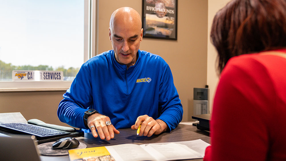 A career services rep meets with a student.