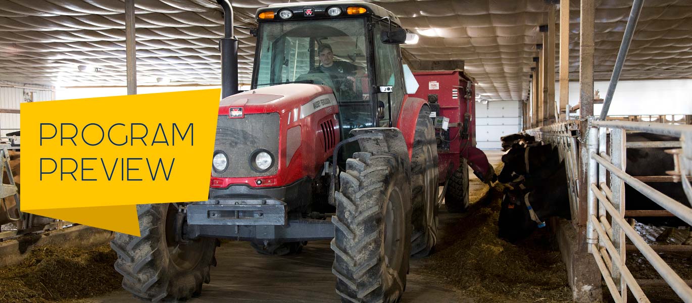 A student drives a tractor through the dairy center.