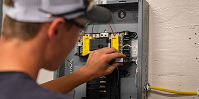 Electrical Student working at a fuse box