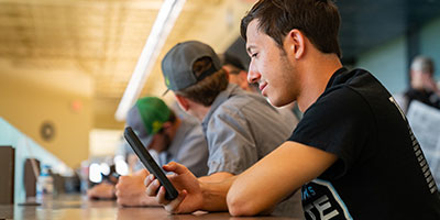 Male student looking at his cell phone