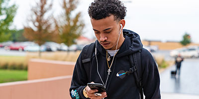 A male student walking outside campus