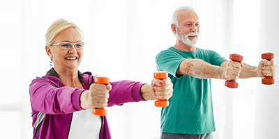Adults using small free weights