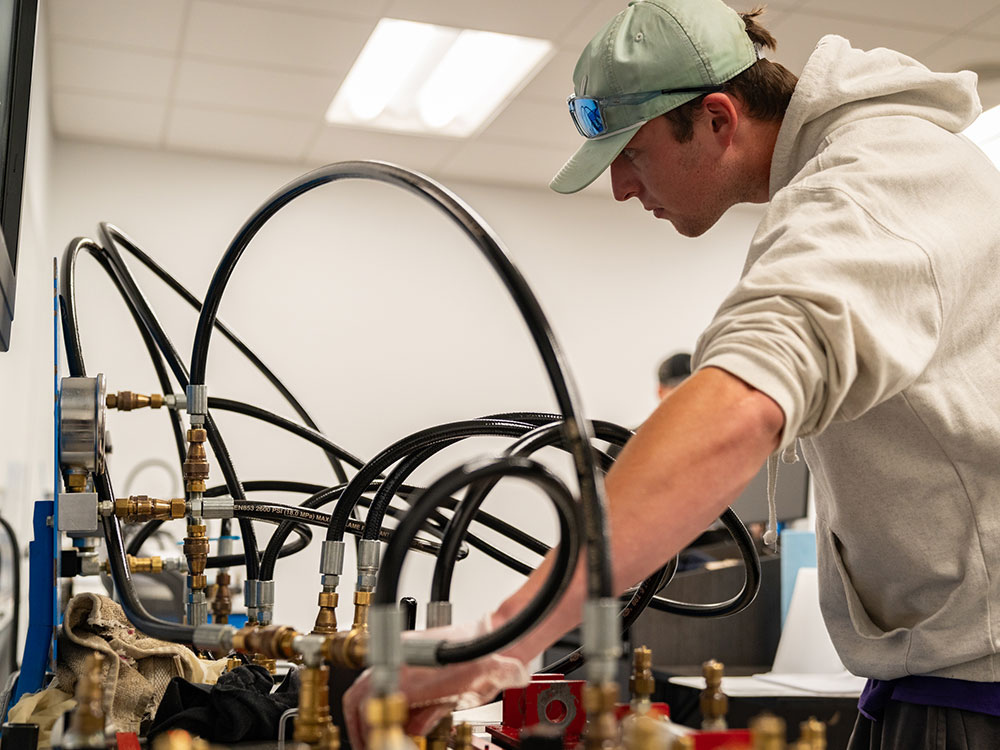 Male student working in an industrial maintenance lab