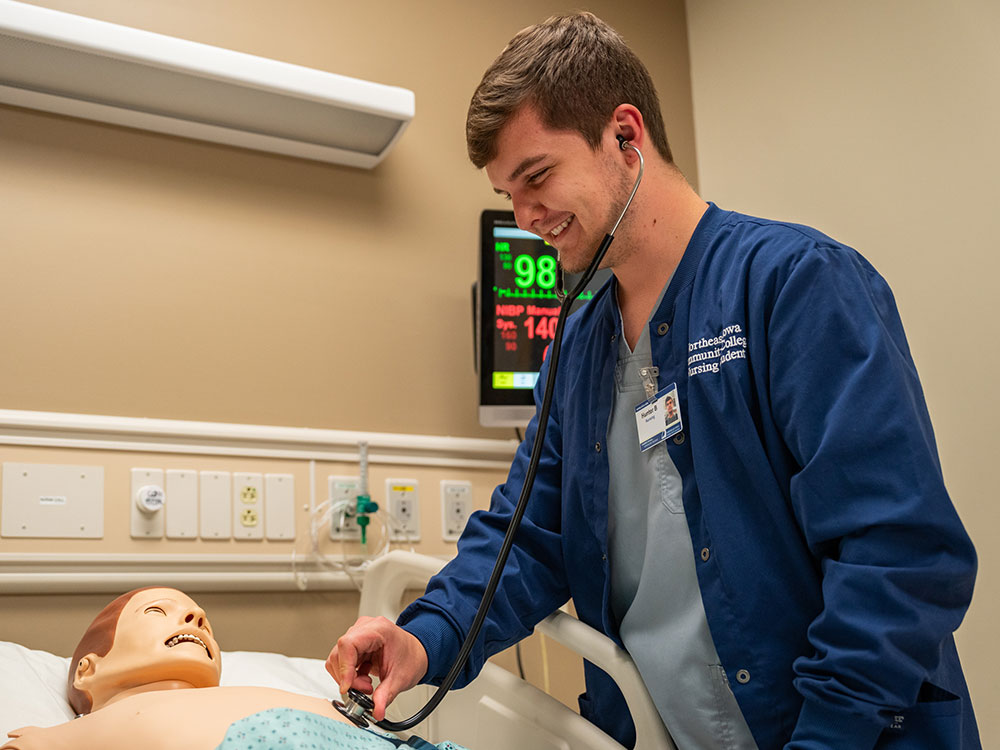 Male nursing student working on a dummy