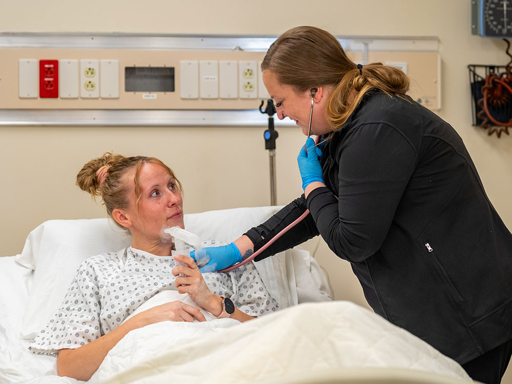 Respiratory care students practice in the health simulation lab.