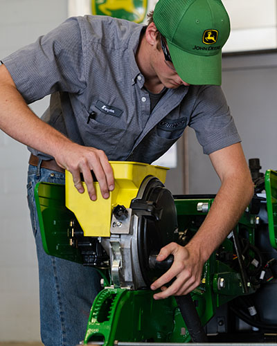 A John Deere TECH program student working in the lab.