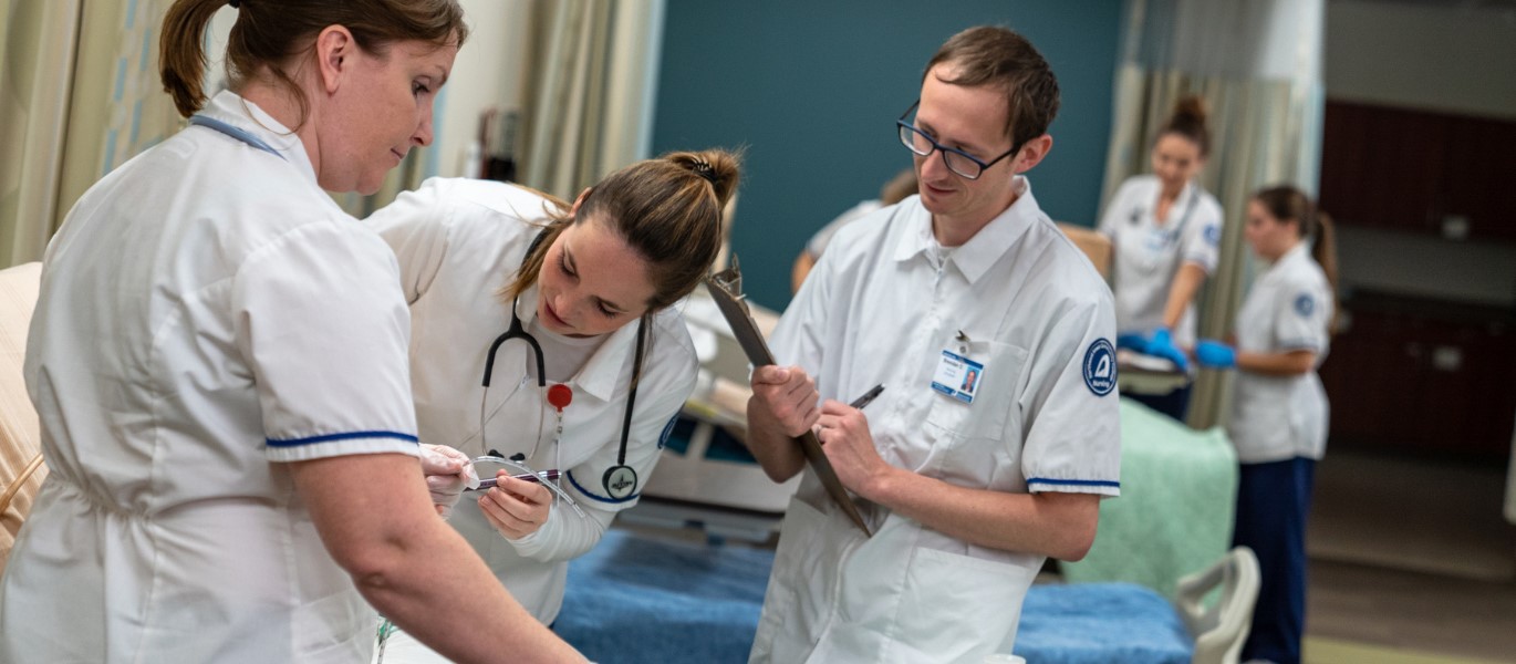 Nursing students practice in healthcare lab