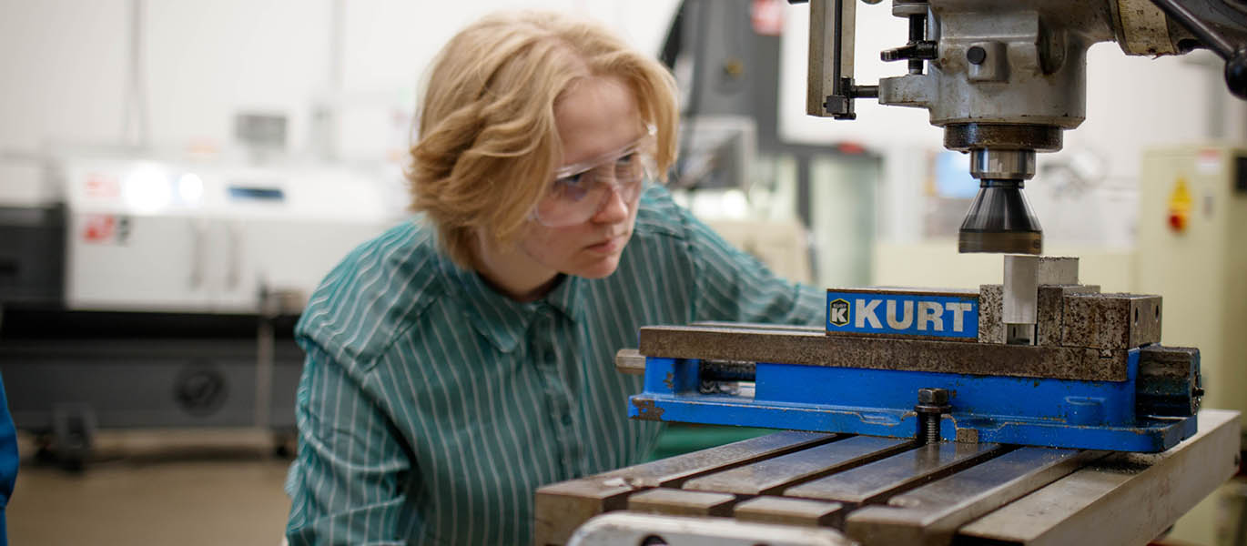 Student working with manufacturing equipment