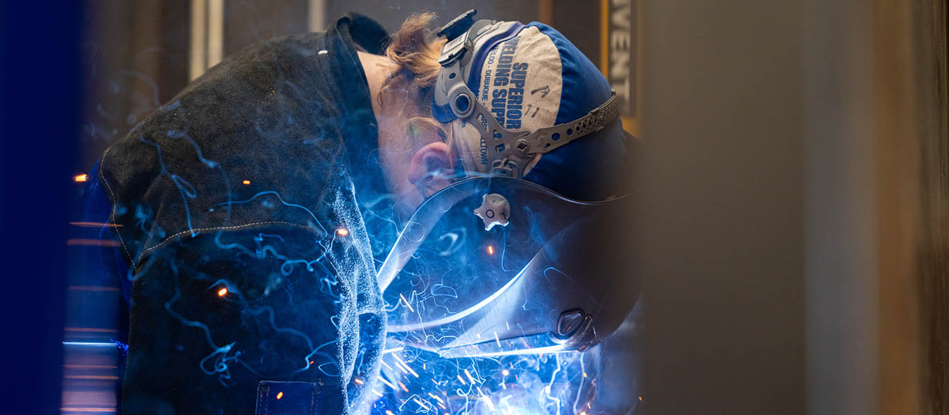 Sparks fly as a student welds