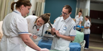 Nursing students practice in healthcare lab