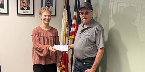 Greg Dougherty gives check to Anna Berns