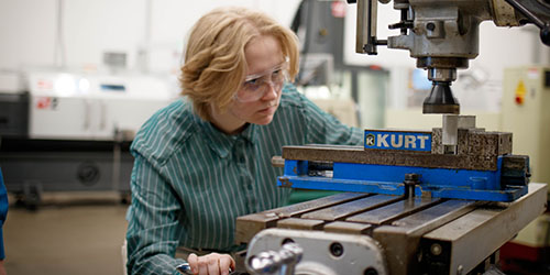 Student working with manufacturing equipment