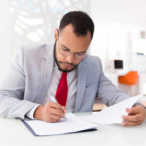 Male professional working at an office desk doing paperwork