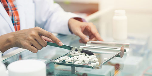 Pharmacist counting pills