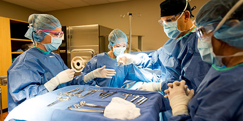 Surgical Technology students practice in a lab with an instructor.