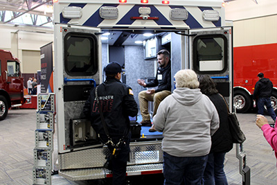 An ambulance vendor talks with attendees in the exhibit hall.