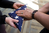 Photo of students folding flag.